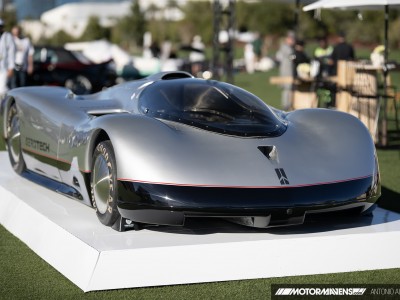 1987 Oldsmobile Aerotech land speed record car displayed on a white pedestal on the lawn at the Las Vegas Concours d'Elegance at Wynn Las Vegas